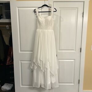 Off the shoulder flowy fit and flare wedding dress.